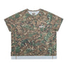 Front view of a unisex short-sleeve athletic T-shirt featuring an all-over brown, olive green, and cream camouflage-style print, a small white “DÉPT.” logo on the chest, and contrasting brown seam detailing along the sides and sleeves. The boxy-fit shirt has a crew neckline and a white perforated mesh panel extending below the hem. Displayed against a plain white background.
